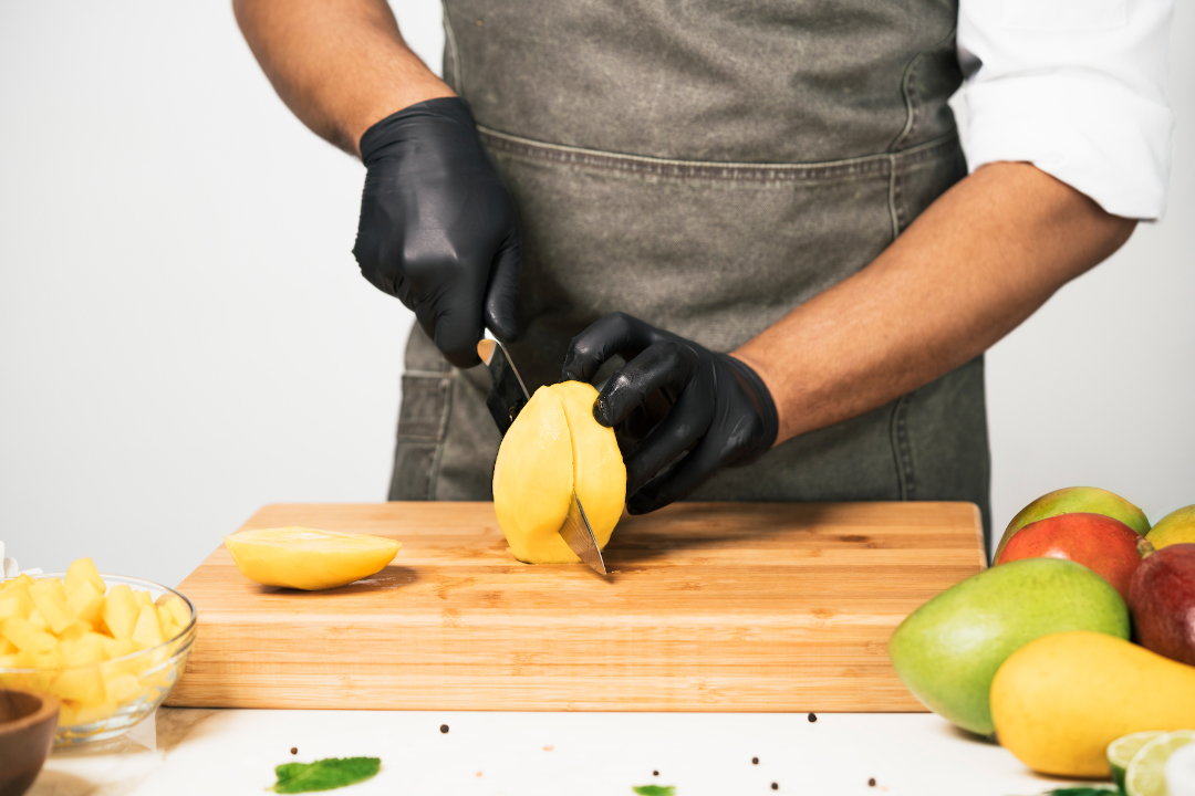 chef cutting mango